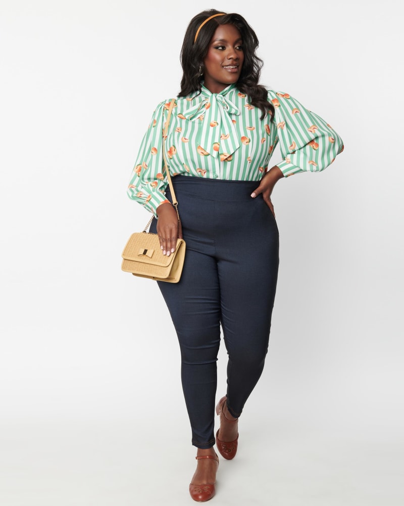 Front of a model wearing a size 1X Unique Vintage Denim Bengaline & Peach Rizzo Cigarette Pants in Blue by Unique Vintage. | dia_product_style_image_id:287521